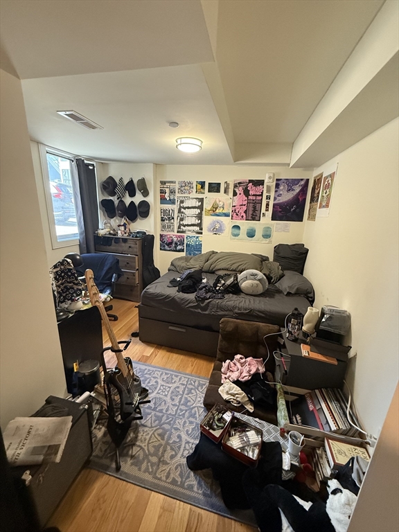 65 Cameron Street, Unit 3 Brookline, MA 02445 - Photo 13 of 16 a living room with furniture and a wooden floor