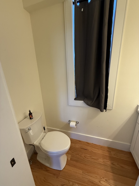 65 Cameron Street, Unit 3 Brookline, MA 02445 - Photo 3 of 16 a bathroom with a toilet and a mirror