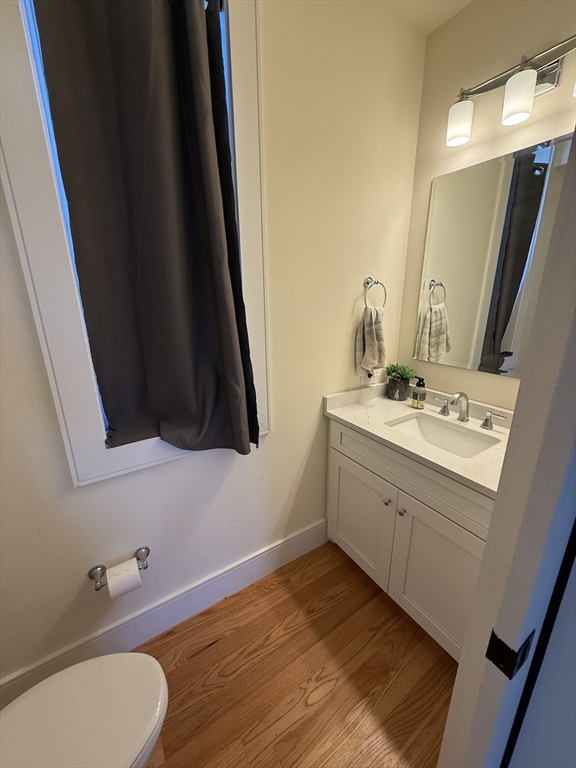 65 Cameron Street, Unit 3 Brookline, MA 02445 - Photo 4 of 16 a bathroom with a sink and a mirror