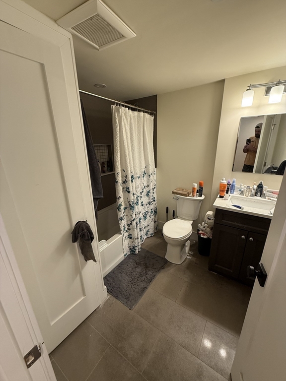 65 Cameron Street, Unit 3 Brookline, MA 02445 - Photo 9 of 16 a bathroom with a sink a toilet a tub and shower