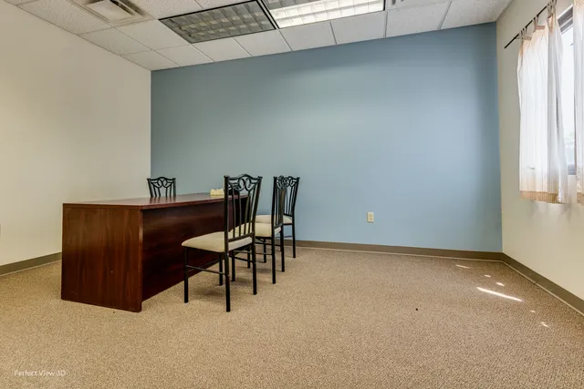 a workspace with furniture and window