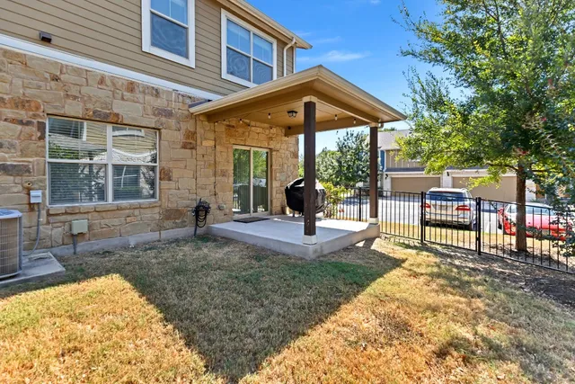 a view of a house with backyard porch and sitting area