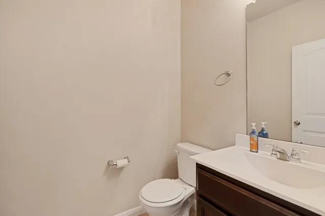 a bathroom with a sink a toilet and mirror