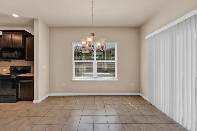 a view of an empty room with a kitchen