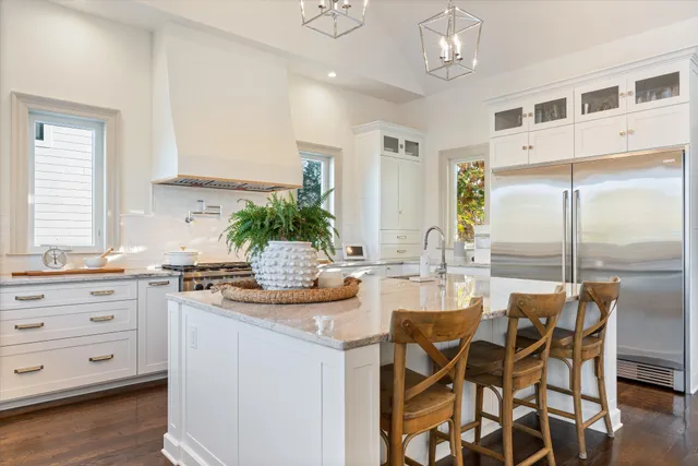 a bathroom with a sink a toilet a mirror and shower curtain