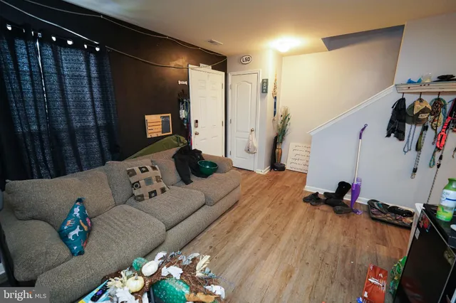 a living room with furniture and wooden floor