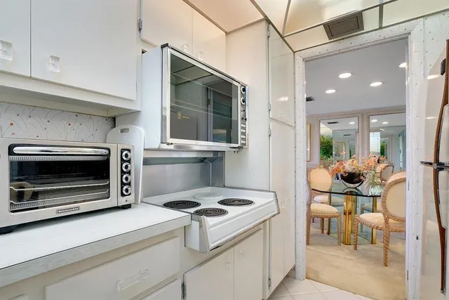 a kitchen with stainless steel appliances a stove a microwave and cabinets