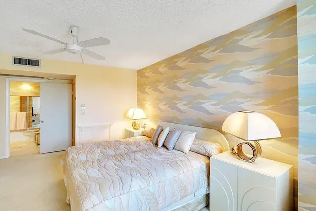 a bedroom with a bed and flowerpot