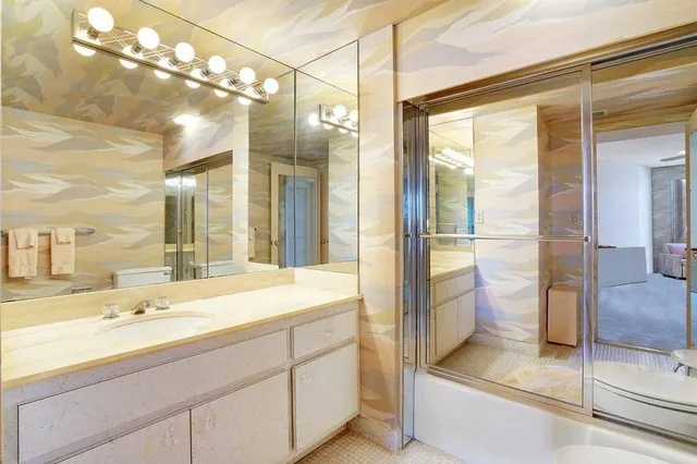 a bathroom with a shower sink and mirror