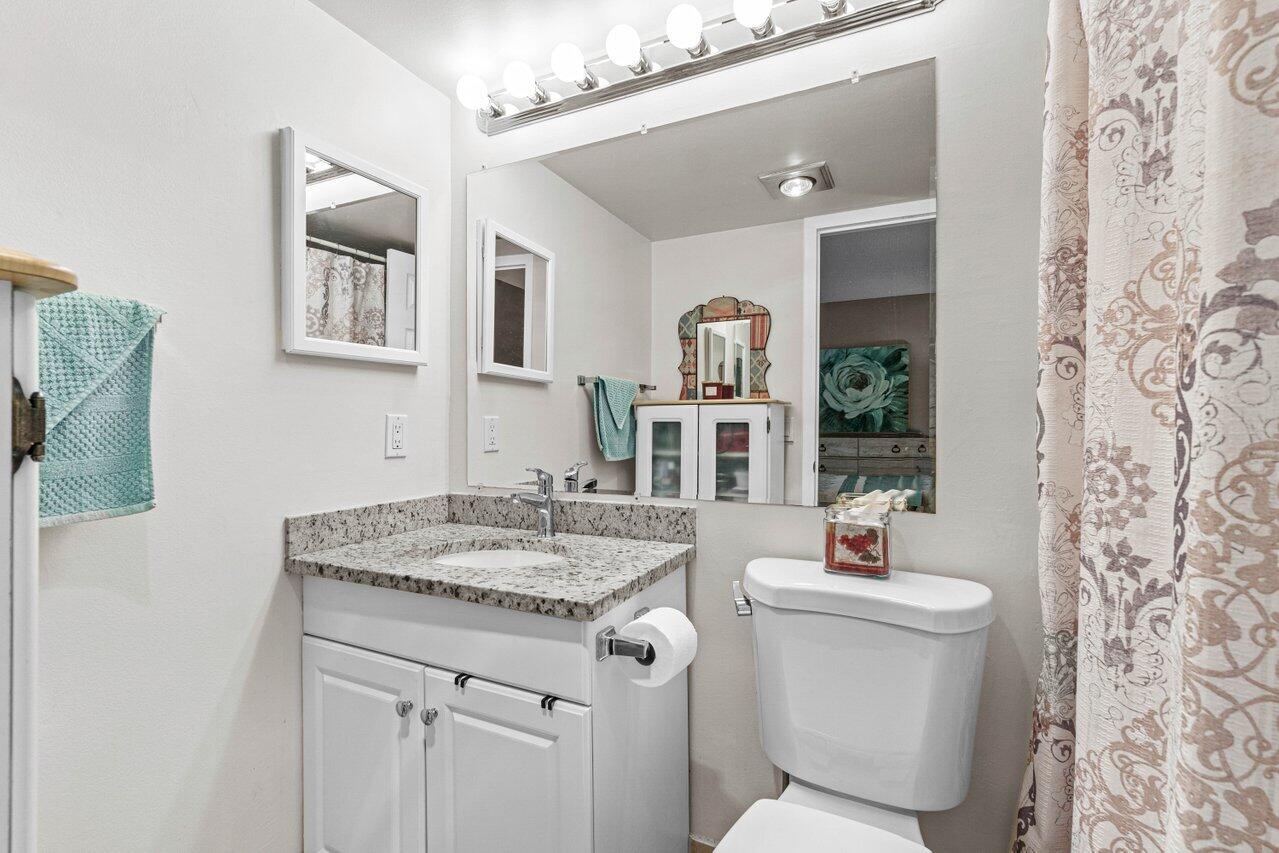 3 Mansfield B Boca Raton, FL 33434 - Photo 20 of 35 a bathroom with a granite countertop sink and a mirror