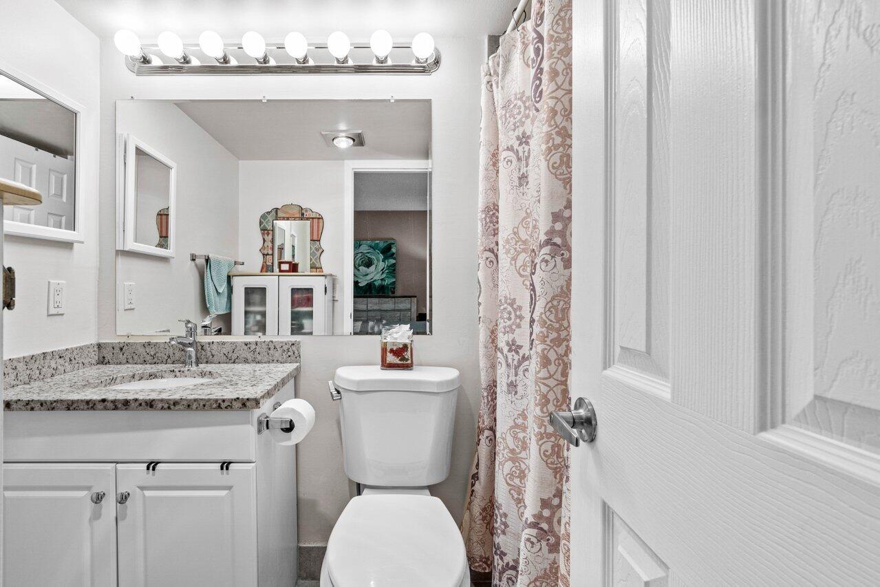 3 Mansfield B Boca Raton, FL 33434 - Photo 22 of 35 a bathroom with a granite countertop sink toilet and shower