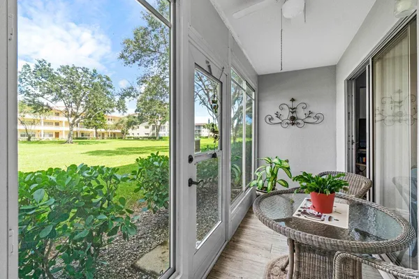 a view of a porch with furniture and garden