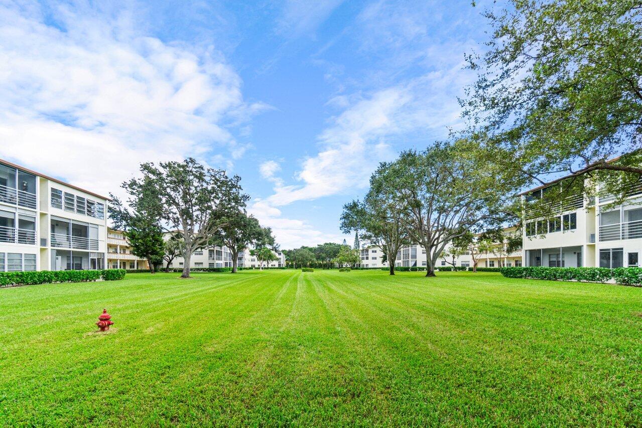 3 Mansfield B Boca Raton, FL 33434 - Photo 29 of 35 a view of a building with a big yard and large trees