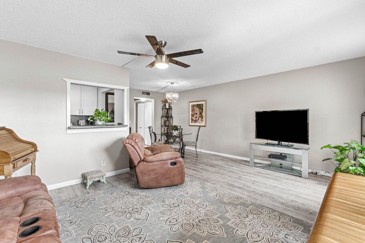 3 Mansfield B Boca Raton, FL 33434 - Photo 10 of 35 a living room with furniture and a flat screen tv