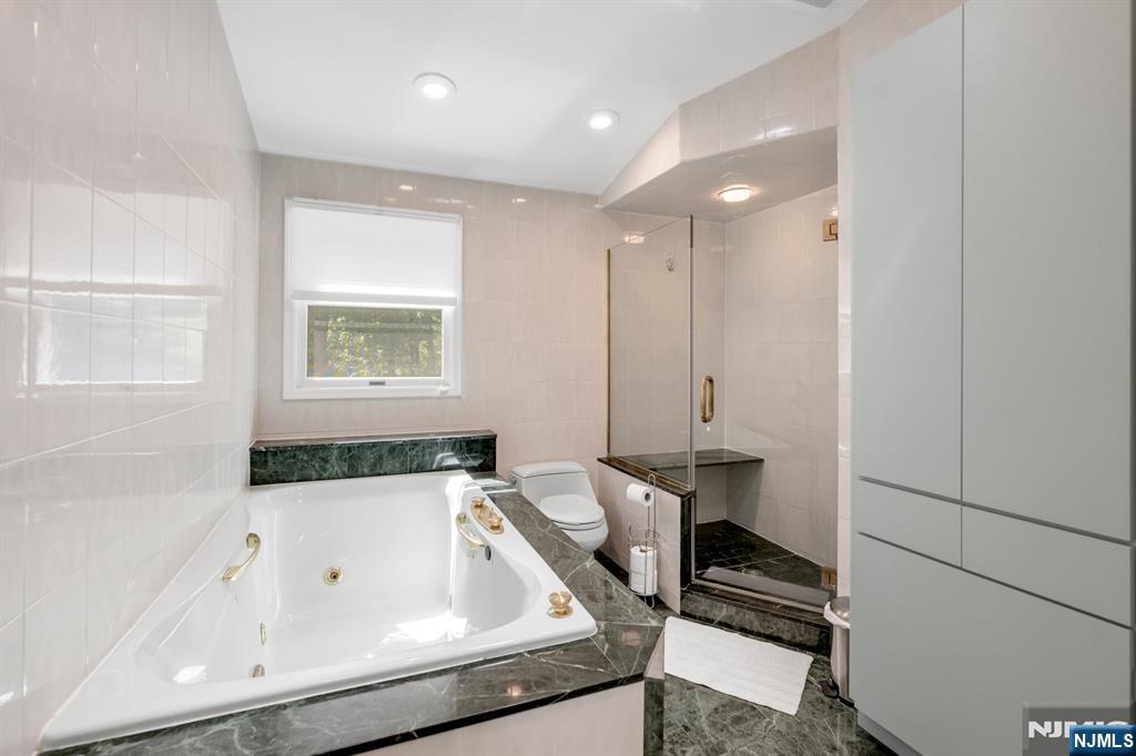 433 Piermont Road Cresskill, NJ 07626 - Photo 26 of 49 a bathroom with a bathtub and a sink