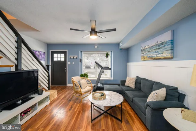 a kitchen with stainless steel appliances granite countertop a stove top oven a sink dishwasher a dining table and chairs with wooden floor