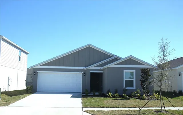 a front view of house with a garden