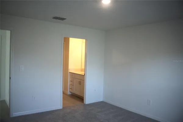 a view of an empty room and a window