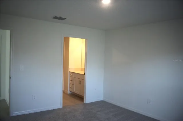 a view of an empty room and a window