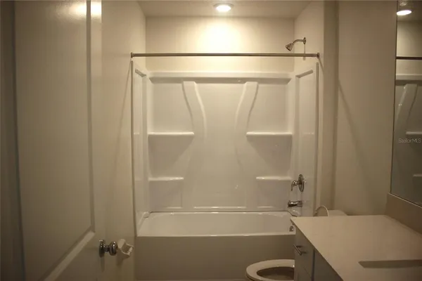 a bathroom with a shower and a toilet