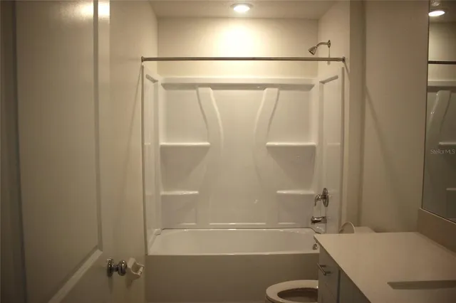 a bathroom with a shower and a toilet