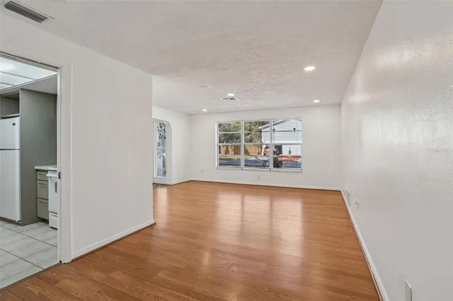 a view of a livingroom with wooden floor and a staircase