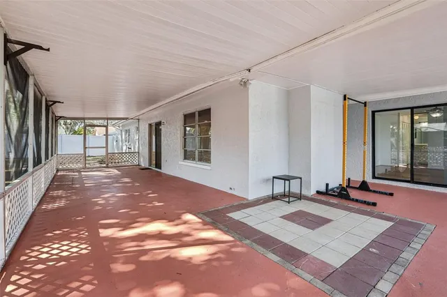 a view of a bedroom with wooden floor and windows
