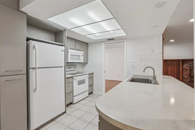 a kitchen with stainless steel appliances a refrigerator sink and stove