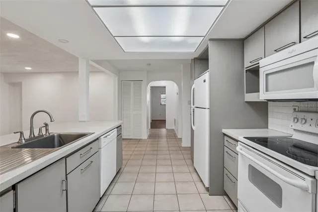 a kitchen with stainless steel appliances granite countertop a sink and cabinets