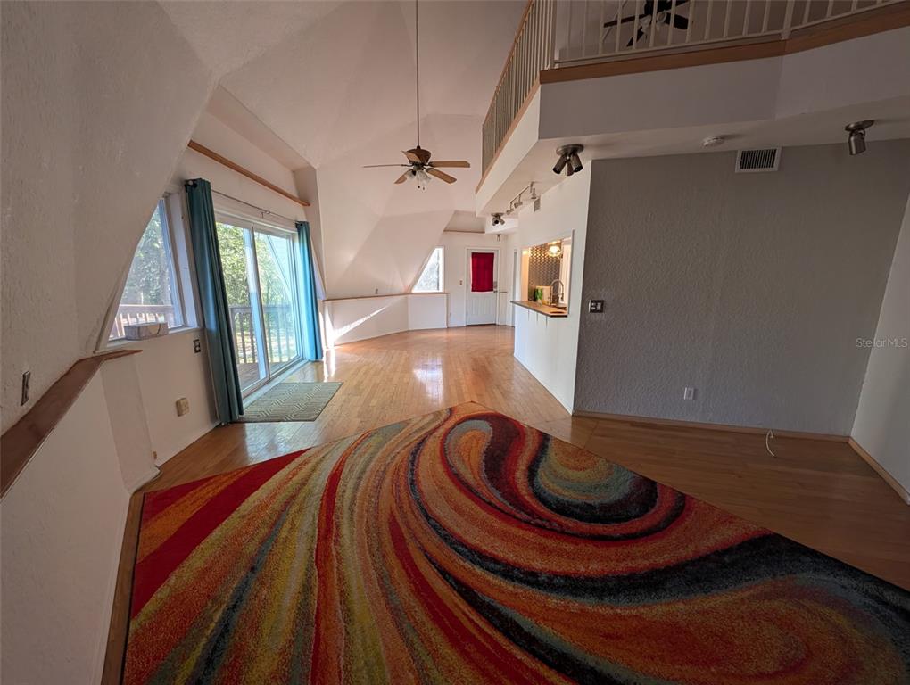 30810 Northeast 78th Street Fort McCoy, FL 32134 - Photo 7 of 9 a room with lots of white furniture and a wooden floor