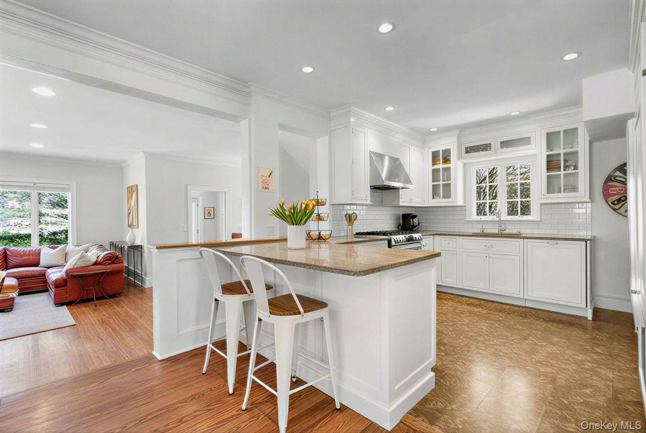 7 Poplar Road Larchmont, NY 10538 - Photo 11 of 46 a kitchen with stainless steel appliances granite countertop a table chairs refrigerator and sink