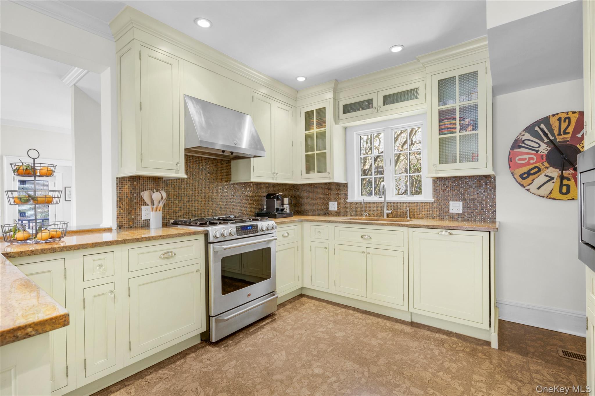 7 Poplar Road Larchmont, NY 10538 - Photo 12 of 46 a kitchen with granite countertop cabinets stainless steel appliances and wooden floor