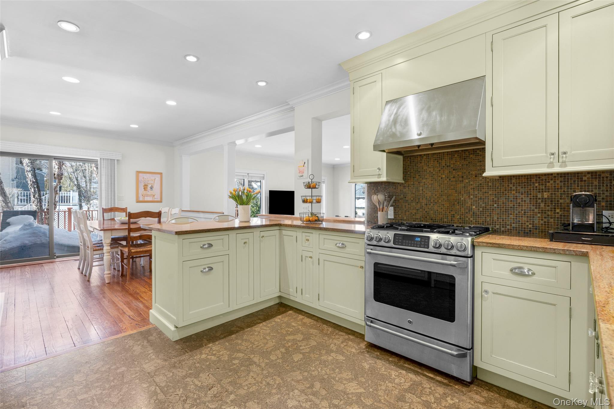 7 Poplar Road Larchmont, NY 10538 - Photo 13 of 46 a kitchen with white cabinets stainless steel appliances and sink