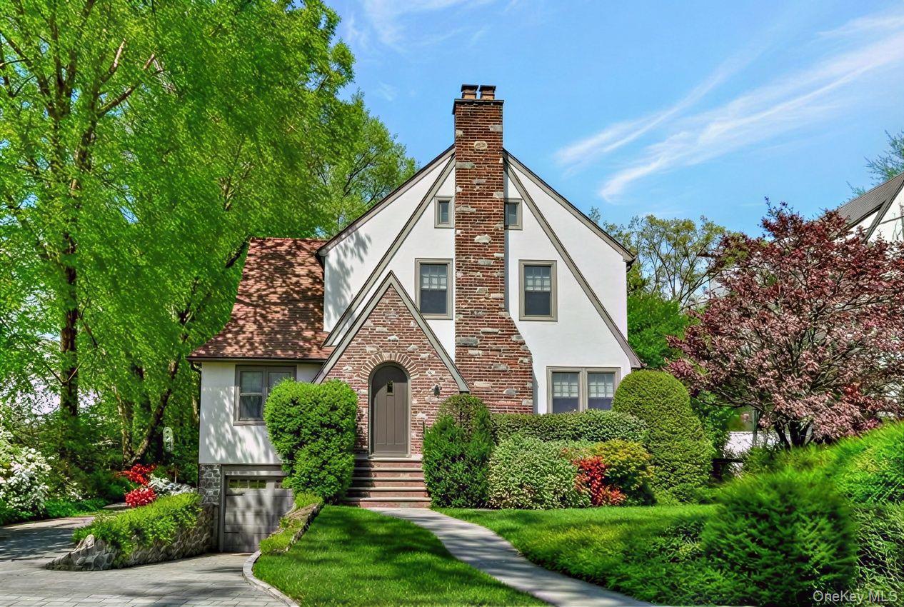 7 Poplar Road Larchmont, NY 10538 - Photo 2 of 46 a front view of a house with a yard