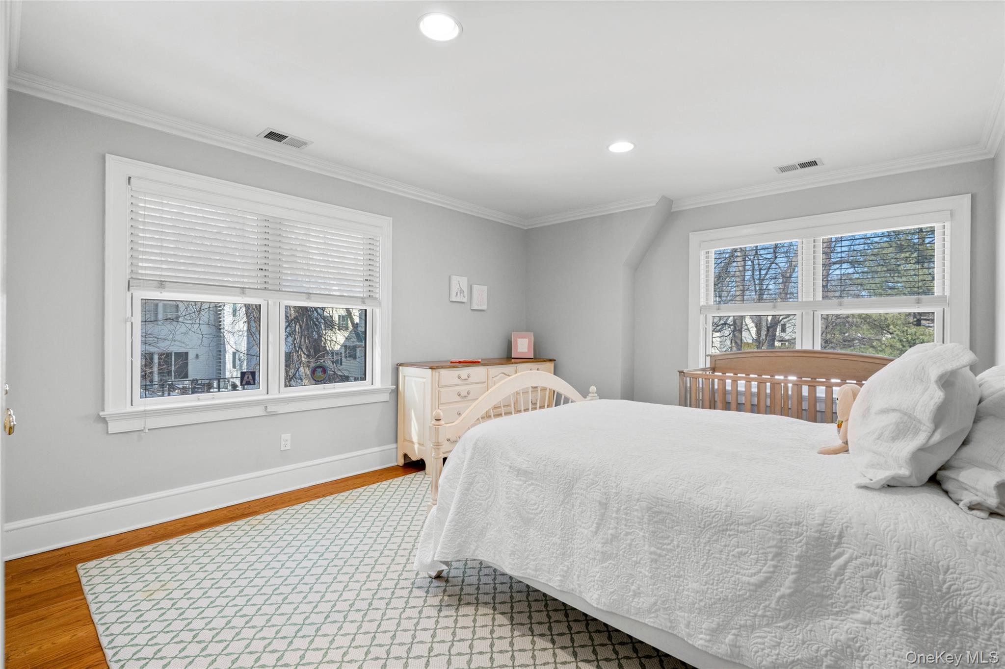 7 Poplar Road Larchmont, NY 10538 - Photo 29 of 46 a bedroom with a bed and a window with chair