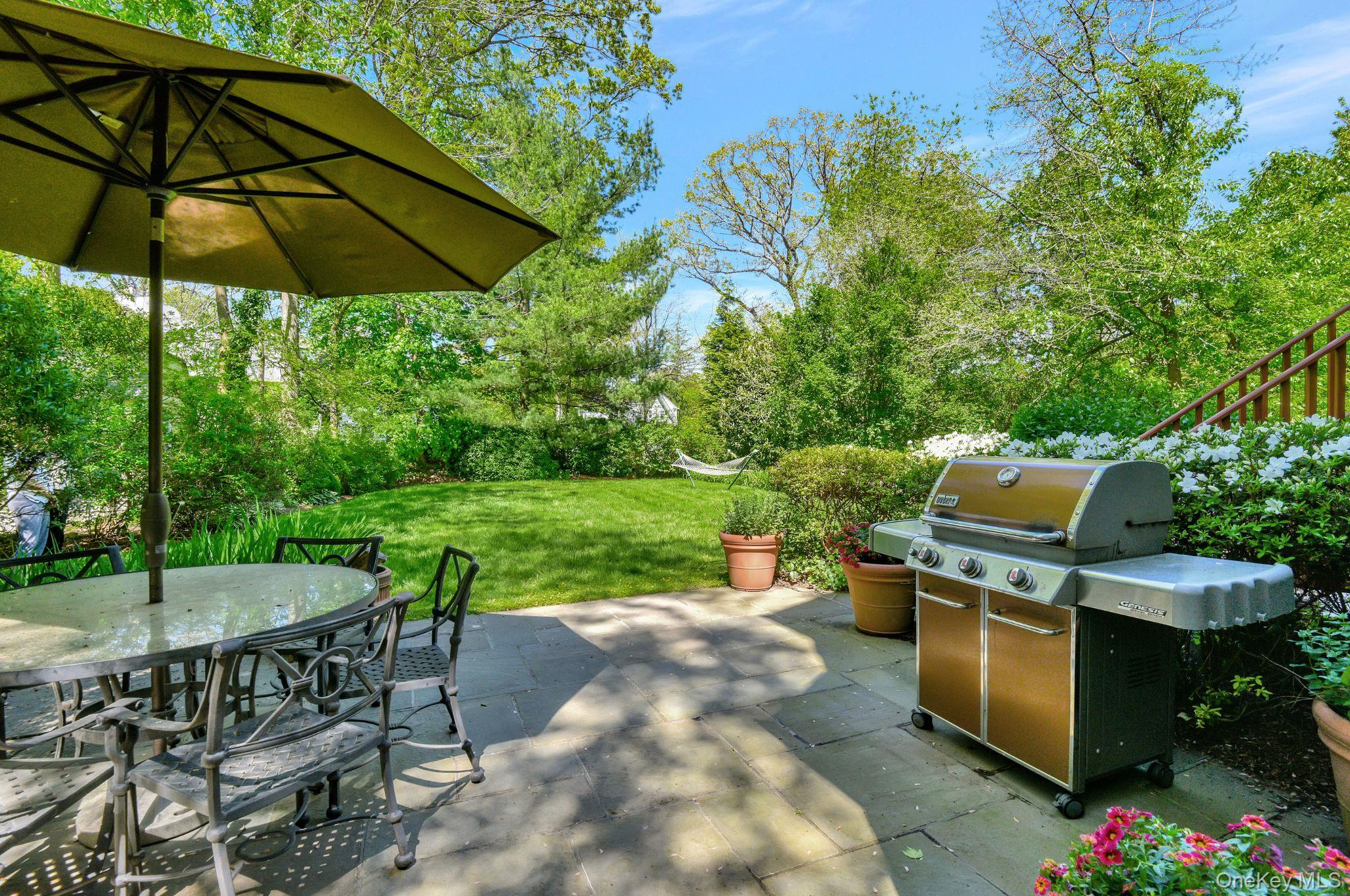 7 Poplar Road Larchmont, NY 10538 - Photo 36 of 46 an outdoor space with furniture and umbrella