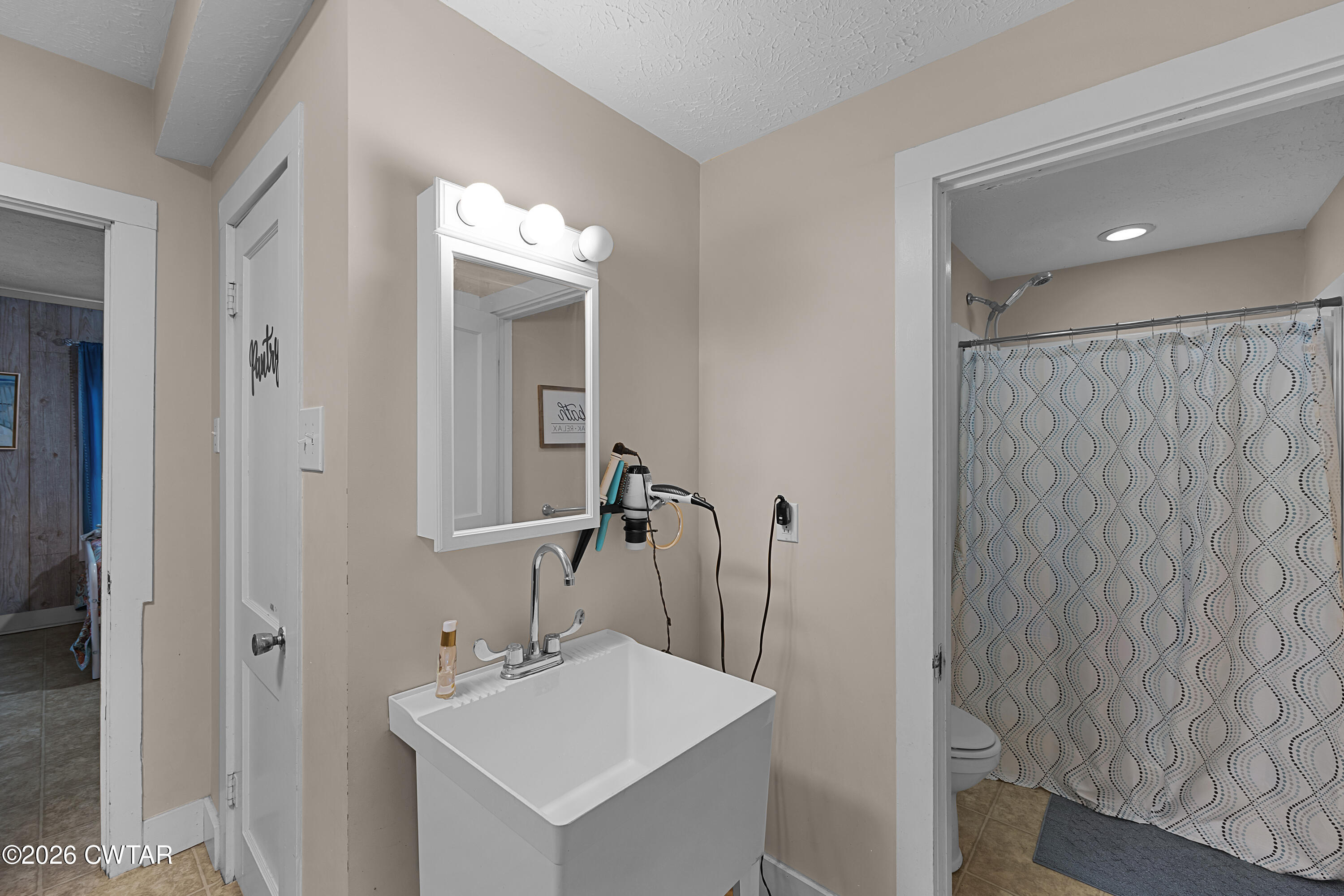 296 Broad Street North Lexington, TN 38351 - Photo 11 of 26 a bathroom with a sink mirror and a shower