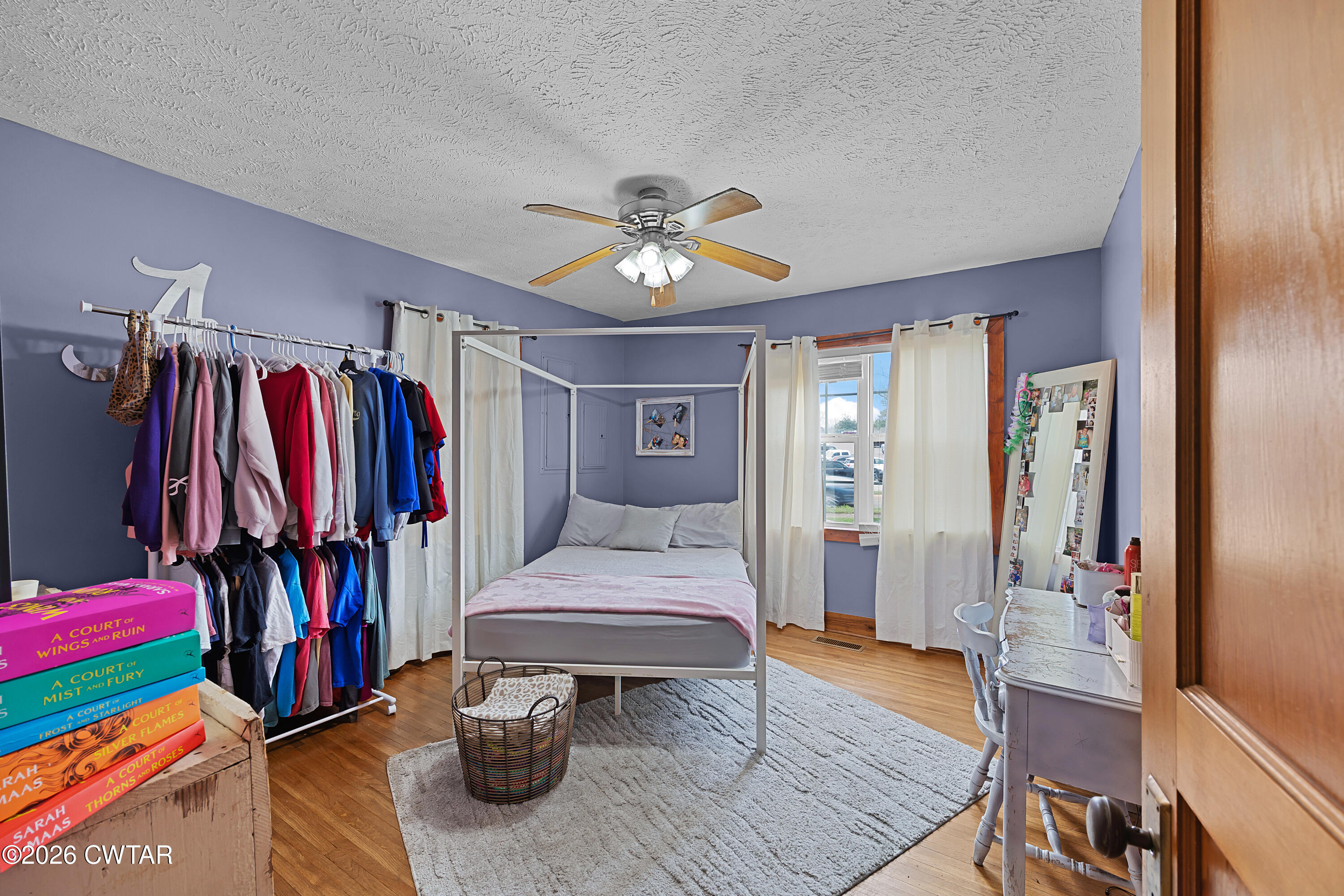 296 Broad Street North Lexington, TN 38351 - Photo 18 of 26 a bedroom with a bed and a chandelier