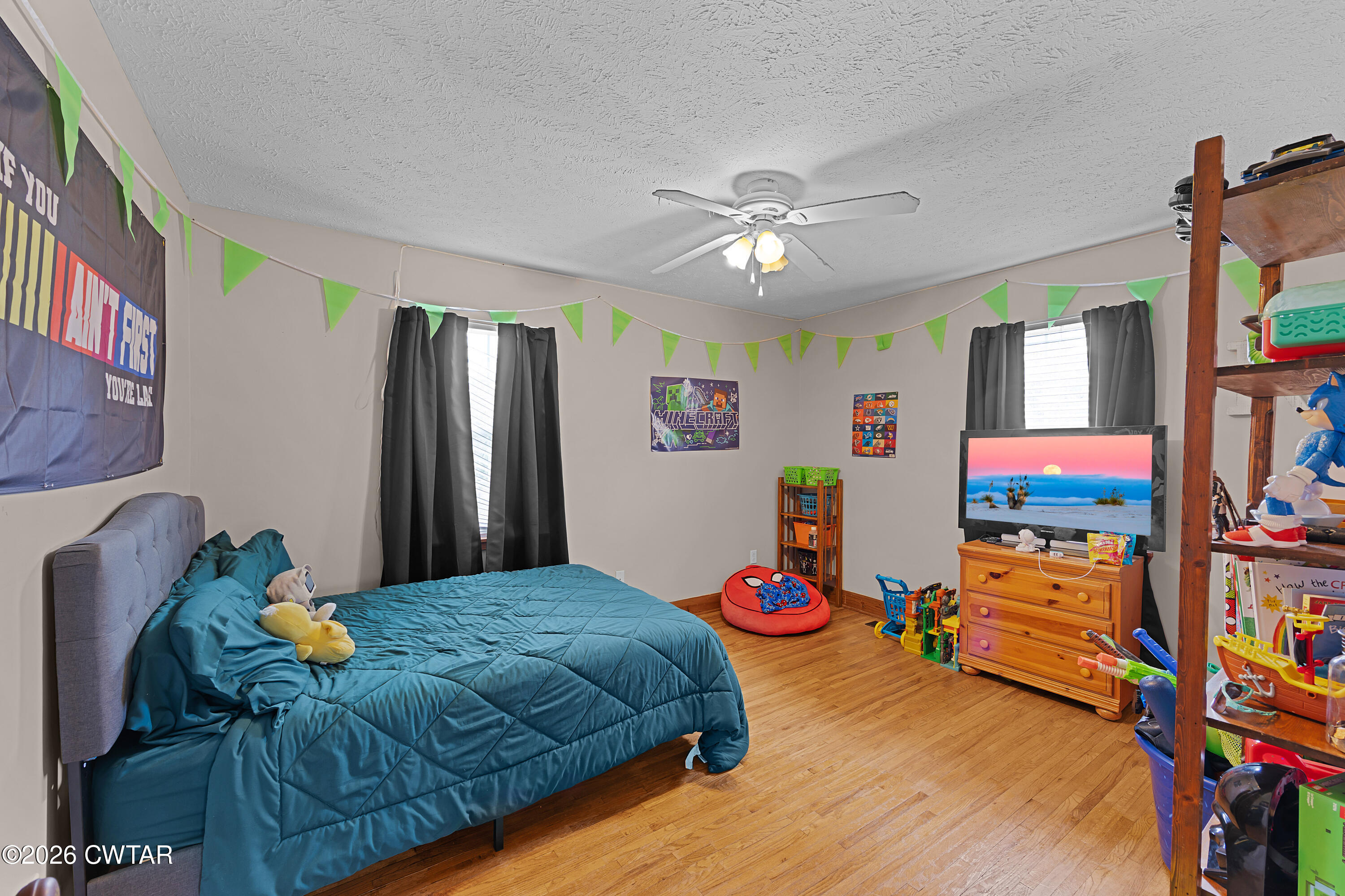 296 Broad Street North Lexington, TN 38351 - Photo 19 of 26 a bedroom with furniture and a flat screen tv
