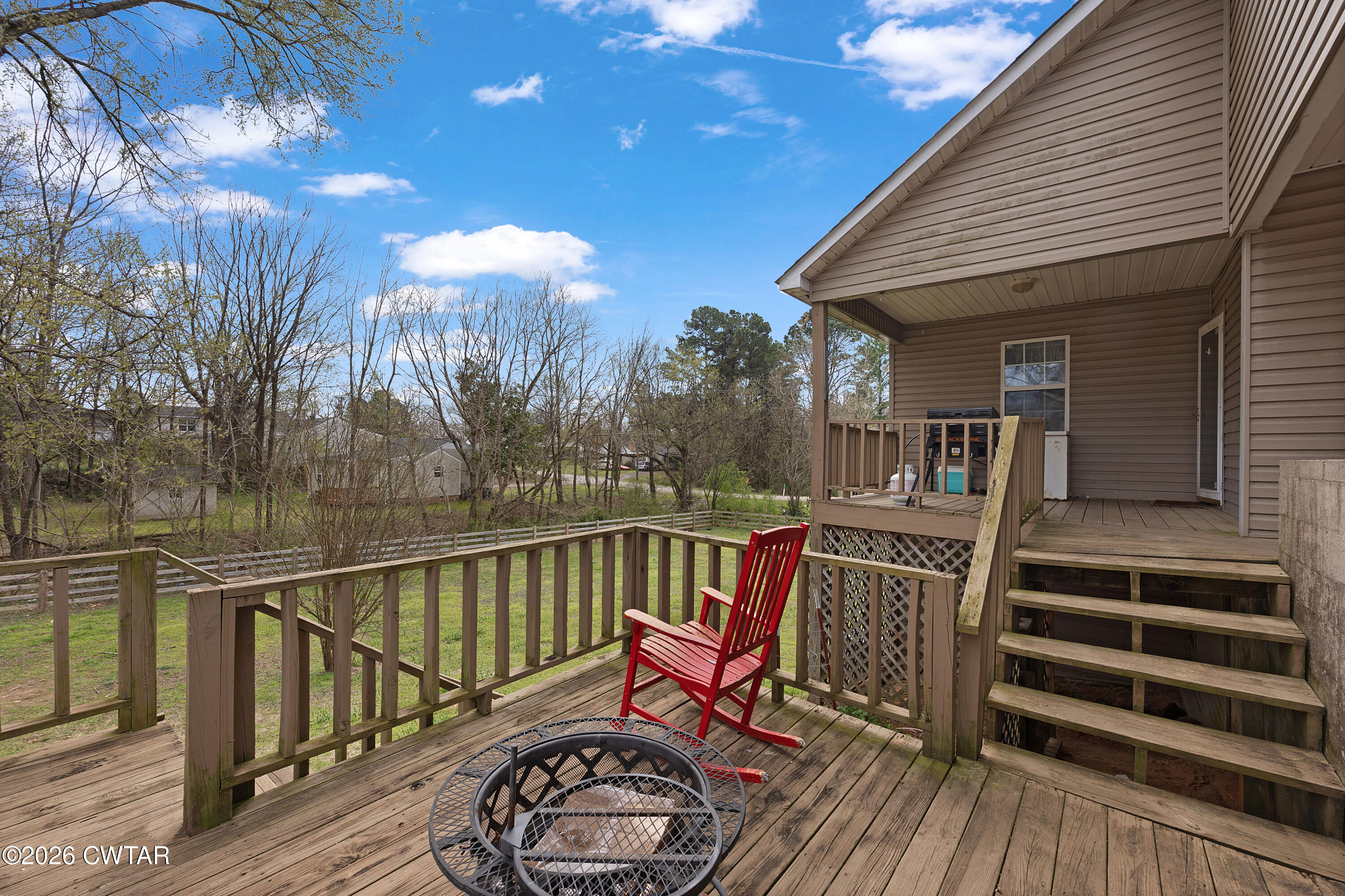 296 Broad Street North Lexington, TN 38351 - Photo 22 of 26 a view of a patio with couches table and chairs and wooden floor