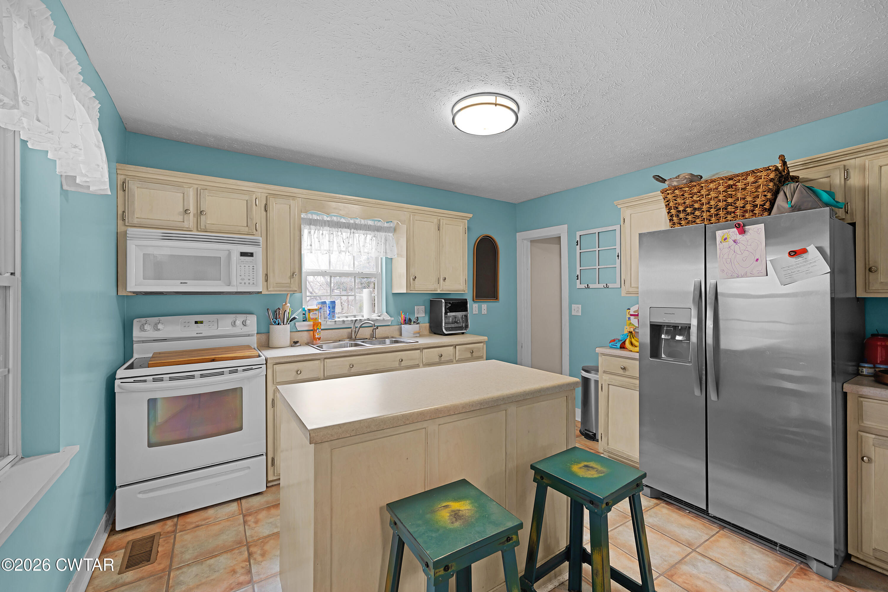 296 Broad Street North Lexington, TN 38351 - Photo 6 of 26 a kitchen with a stove a refrigerator and a stove top oven