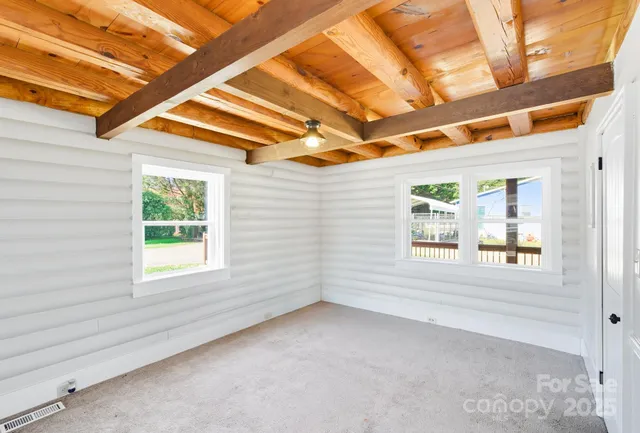 a view of a room with a window and a ceiling fan