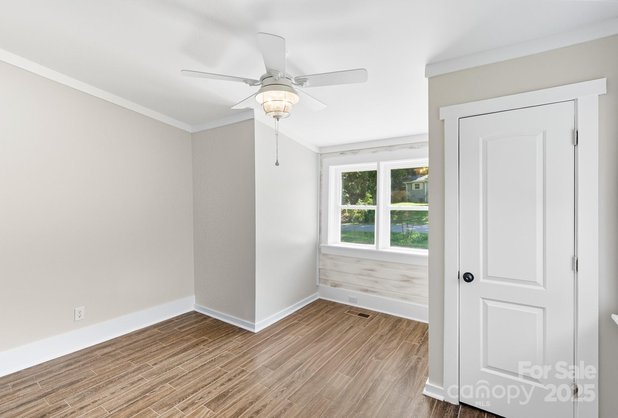 119 Yates Street Dallas, NC 28034 - Photo 19 of 47 a view of an empty room with wooden floor and a window