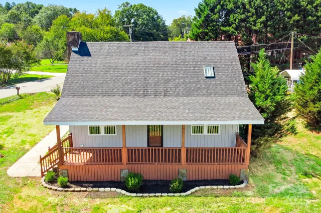 a aerial view of a house with a yard and potted plants