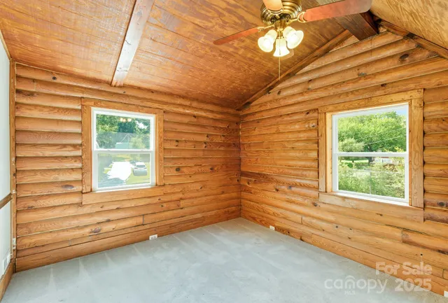 a view of a room with a window and ceiling fan