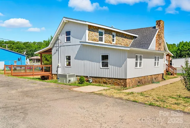 a front view of a house with a dirt road and garage