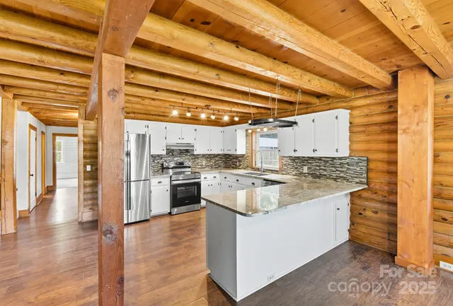 a kitchen with a stove and a kitchen view