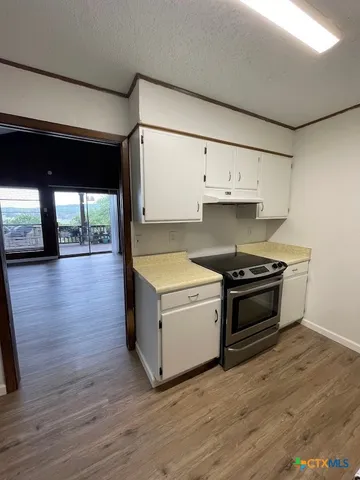 a kitchen with wooden floors and appliances