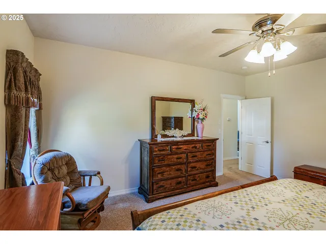 a living room with furniture and a dresser