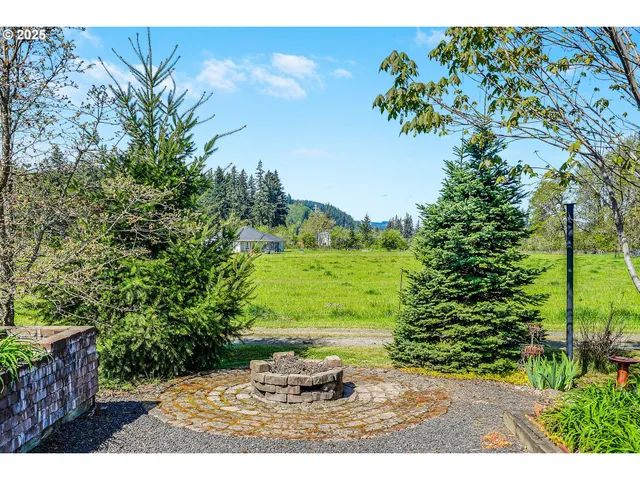 a view of a patio with table and chairs and potted plants